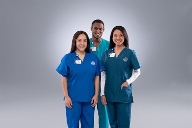 Two women and a man wearing scrubs